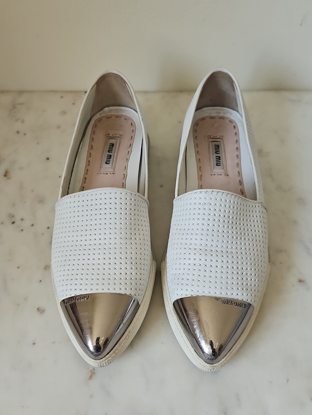 MIU MIU: White Perforated Leather SlipOns with Metallic Logo Silver Toe Caps